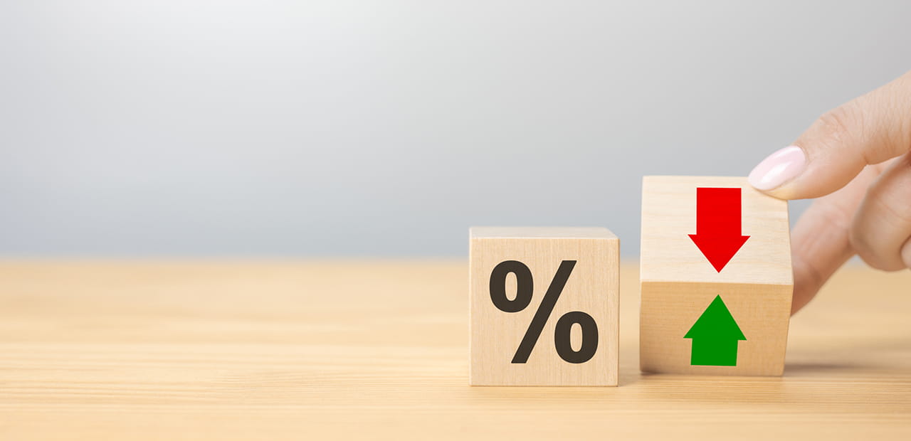 Interest rate financial and mortgage rates concept. Hand flip wood cube change arrow down to up.