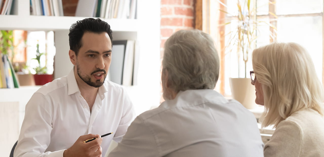 An elderly couple having a discussion with a financial advisor